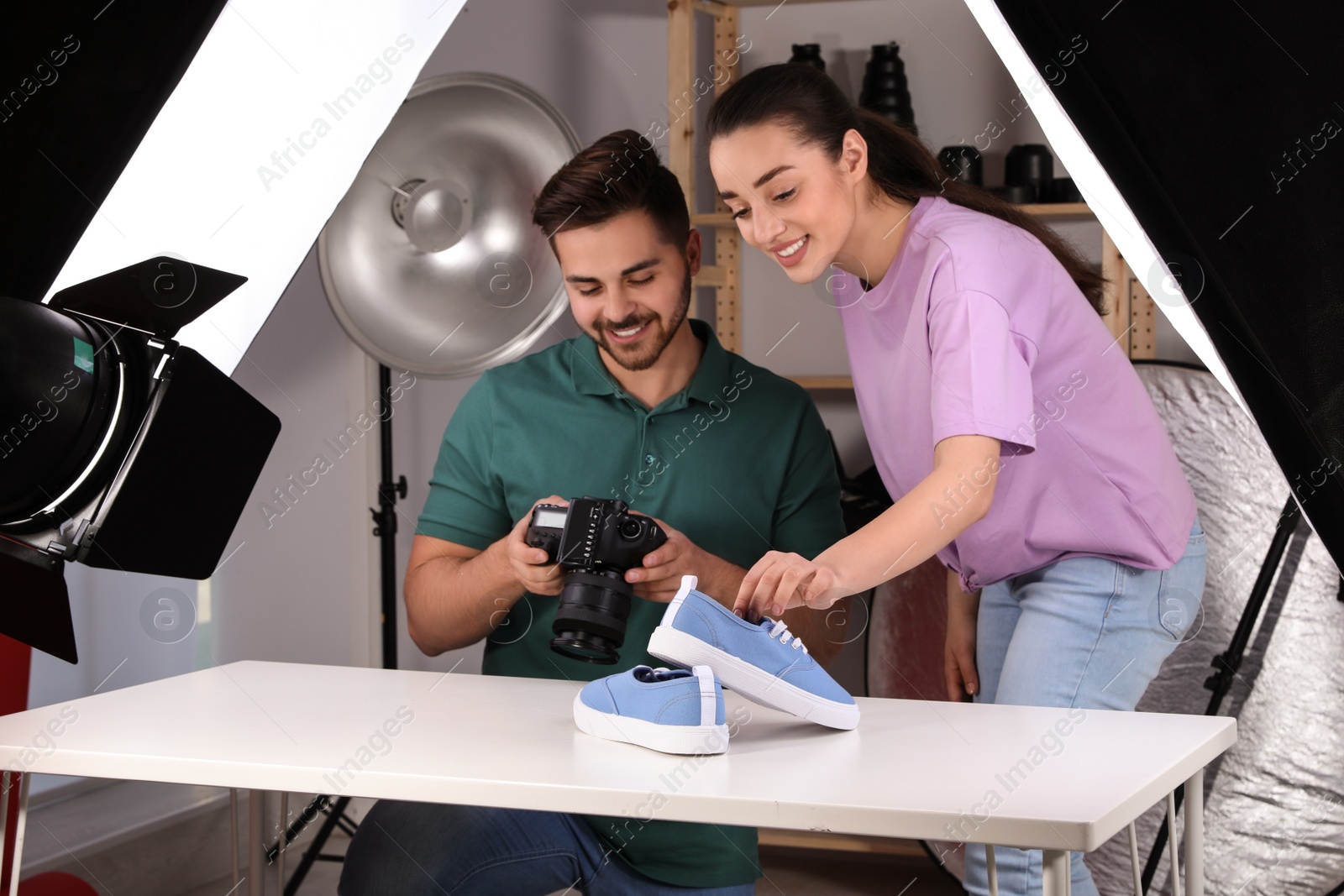 Photo of Professional photographers shooting stylish shoes in studio