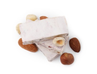 Photo of Pieces of delicious nougat and nuts on white background, top view