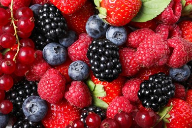 Photo of Different fresh ripe berries as background, top view