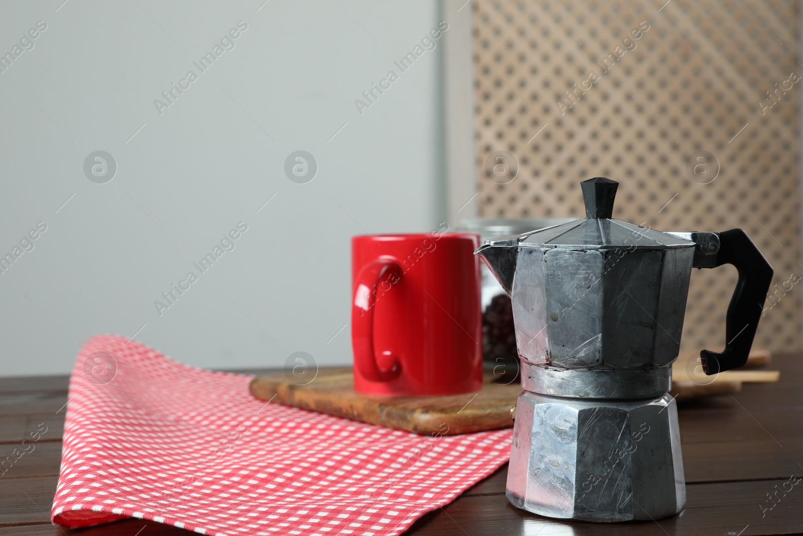 Photo of Moka pot on wooden table indoors, space for text