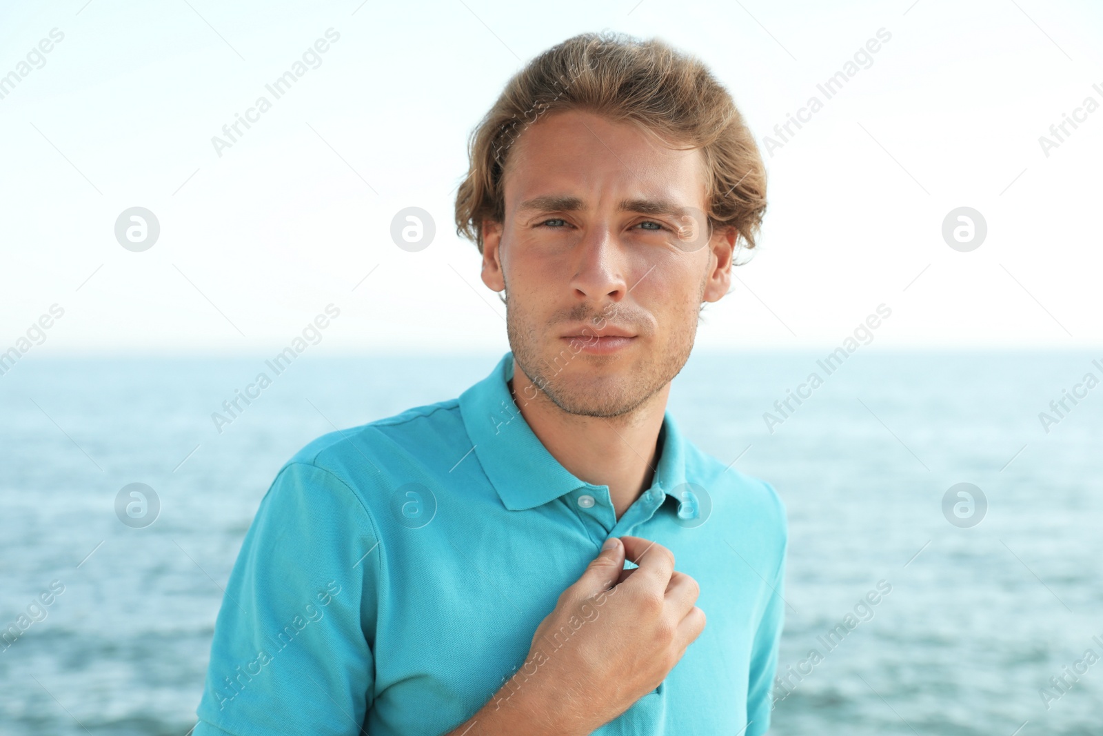 Photo of Portrait of handsome young man near sea