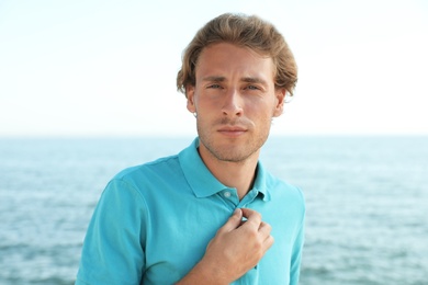 Portrait of handsome young man near sea