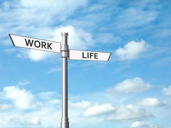 Signpost against beautiful blue sky, space for text. Concept of balance between work and life