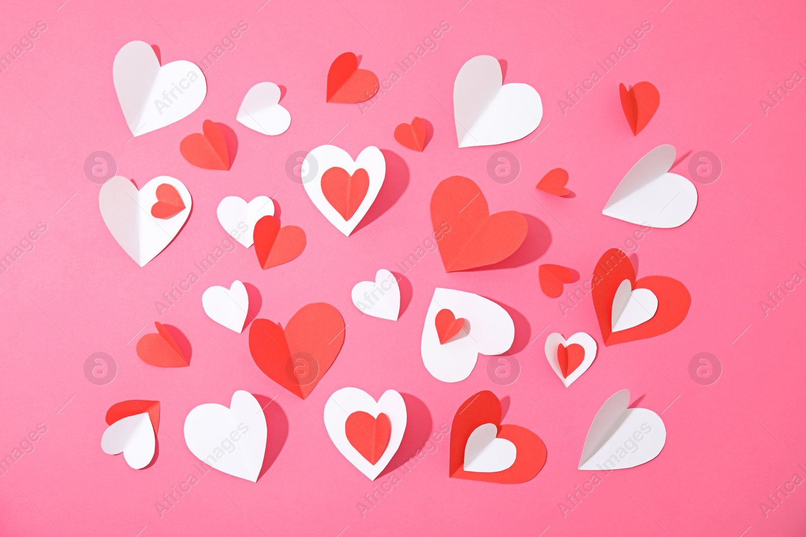 Photo of Small paper hearts on color background, top view