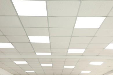 Photo of White ceiling with lighting in office room