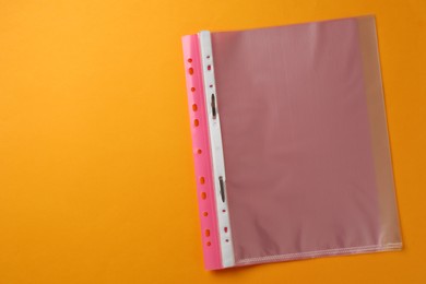 Photo of File folder with punched pockets on orange background, top view. Space for text
