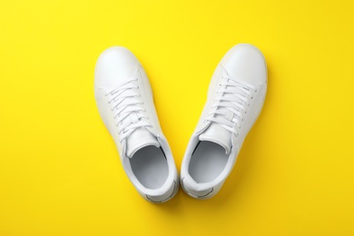 Photo of Pair of sneakers on color background, flat lay