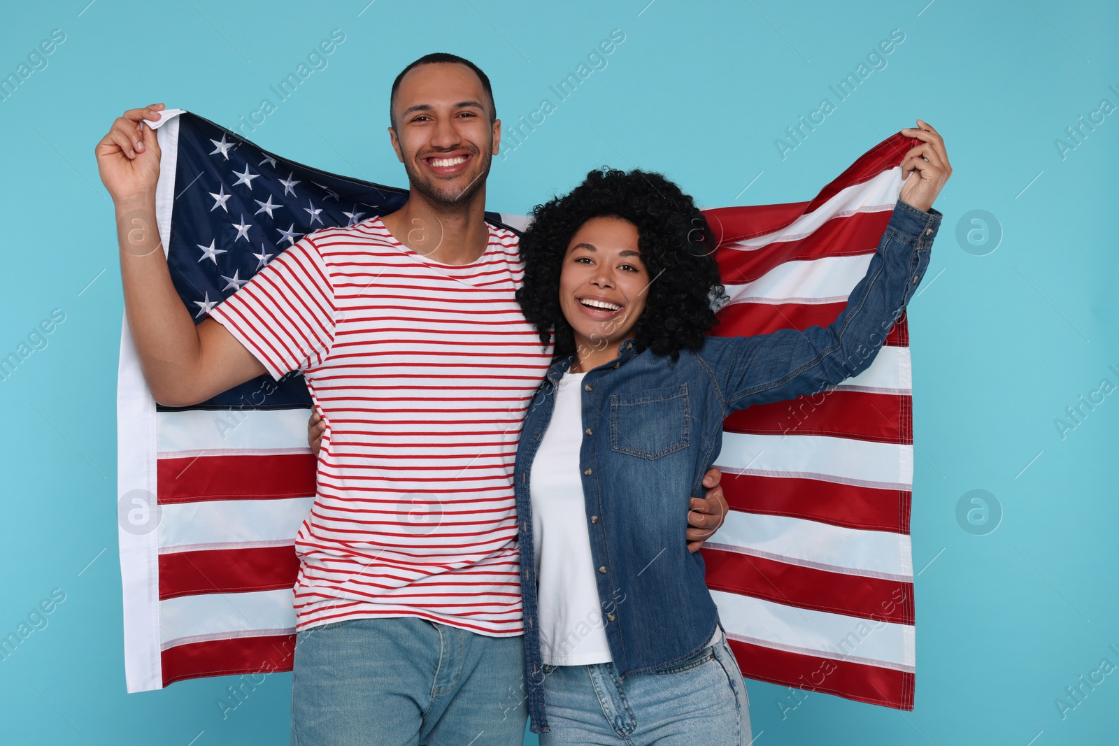 Photo of 4th of July - Independence Day of USA. Happy couple with American flag on light blue background