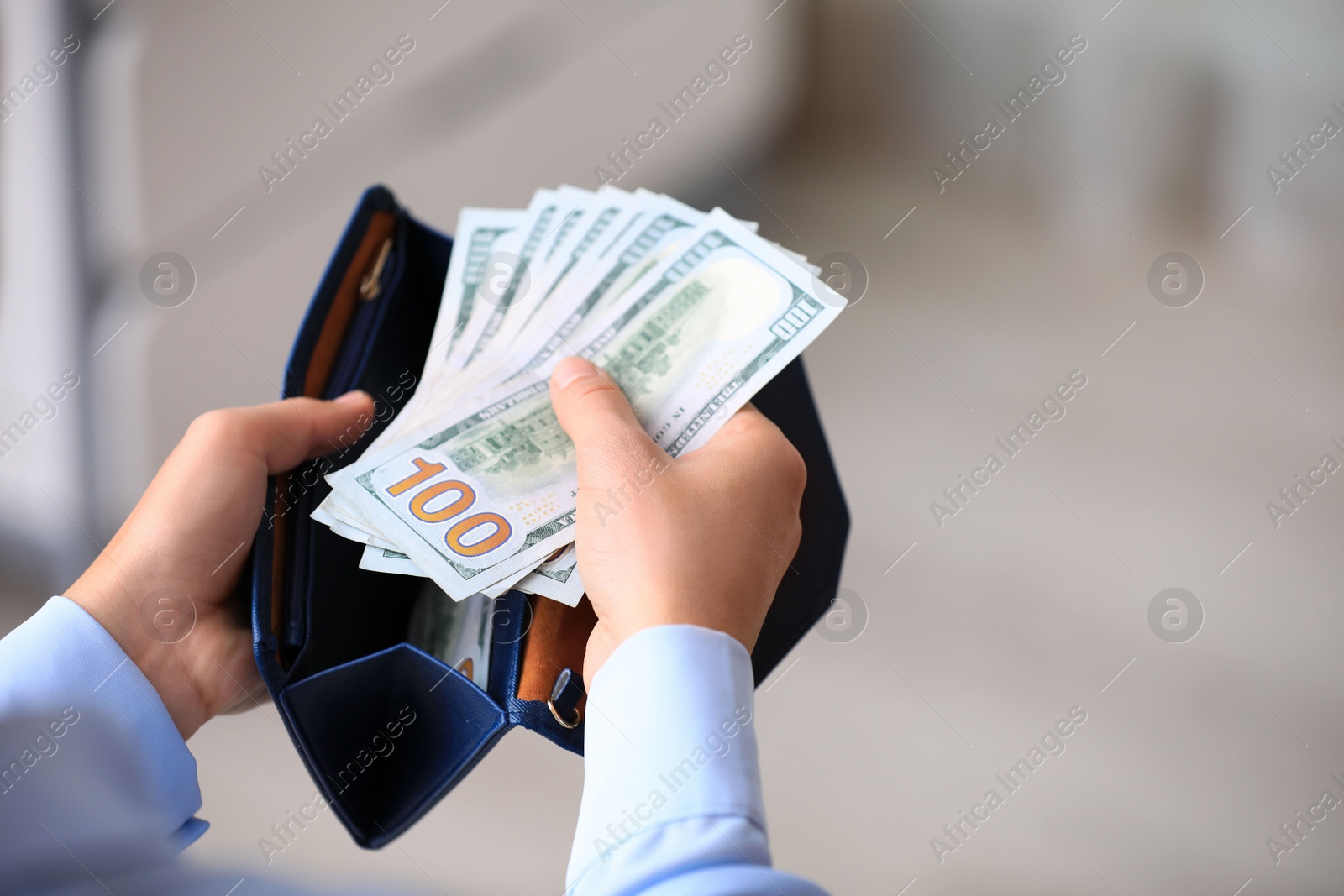 Photo of Woman with American money in wallet indoors, closeup