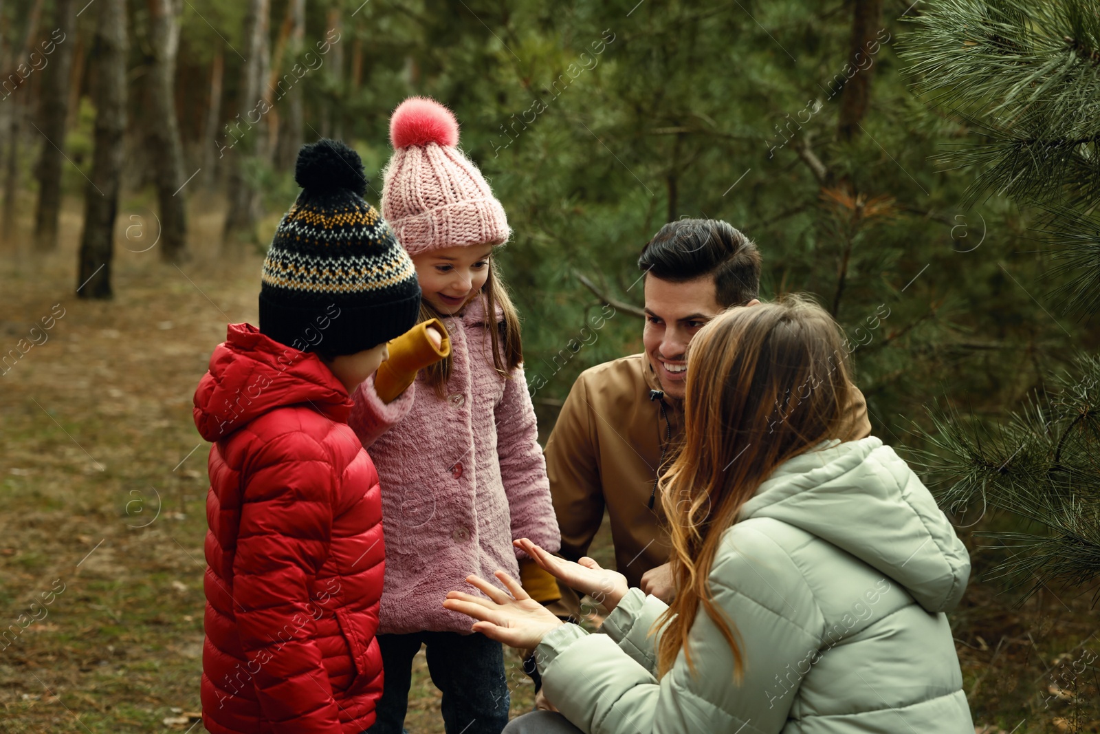 Photo of Happy family spending time together in forest