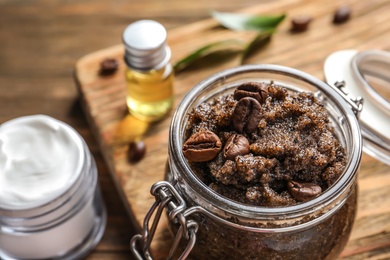 Photo of Glass jar of coffee scrub on table