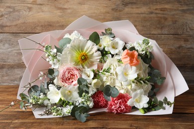 Bouquet of beautiful flowers on wooden table