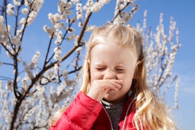 Photo of Little girl suffering from seasonal allergy outdoors