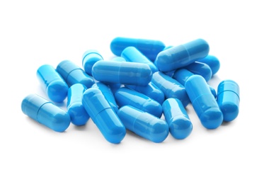 Photo of Blue capsules on white background