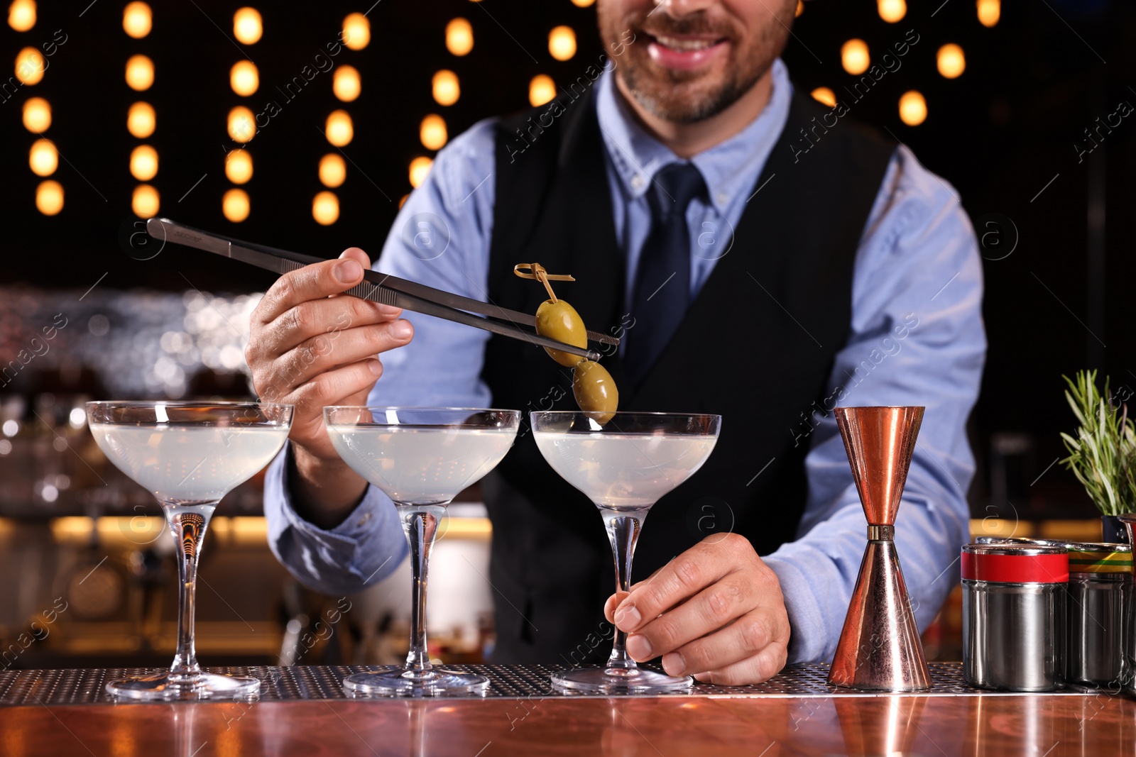 Photo of Bartender preparing fresh alcoholic cocktail in bar, closeup