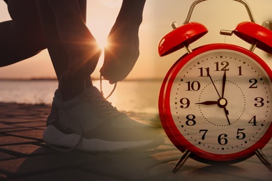 Image of Time to do morning exercises. Double exposure of woman tying shoelaces before running outdoors and alarm clock