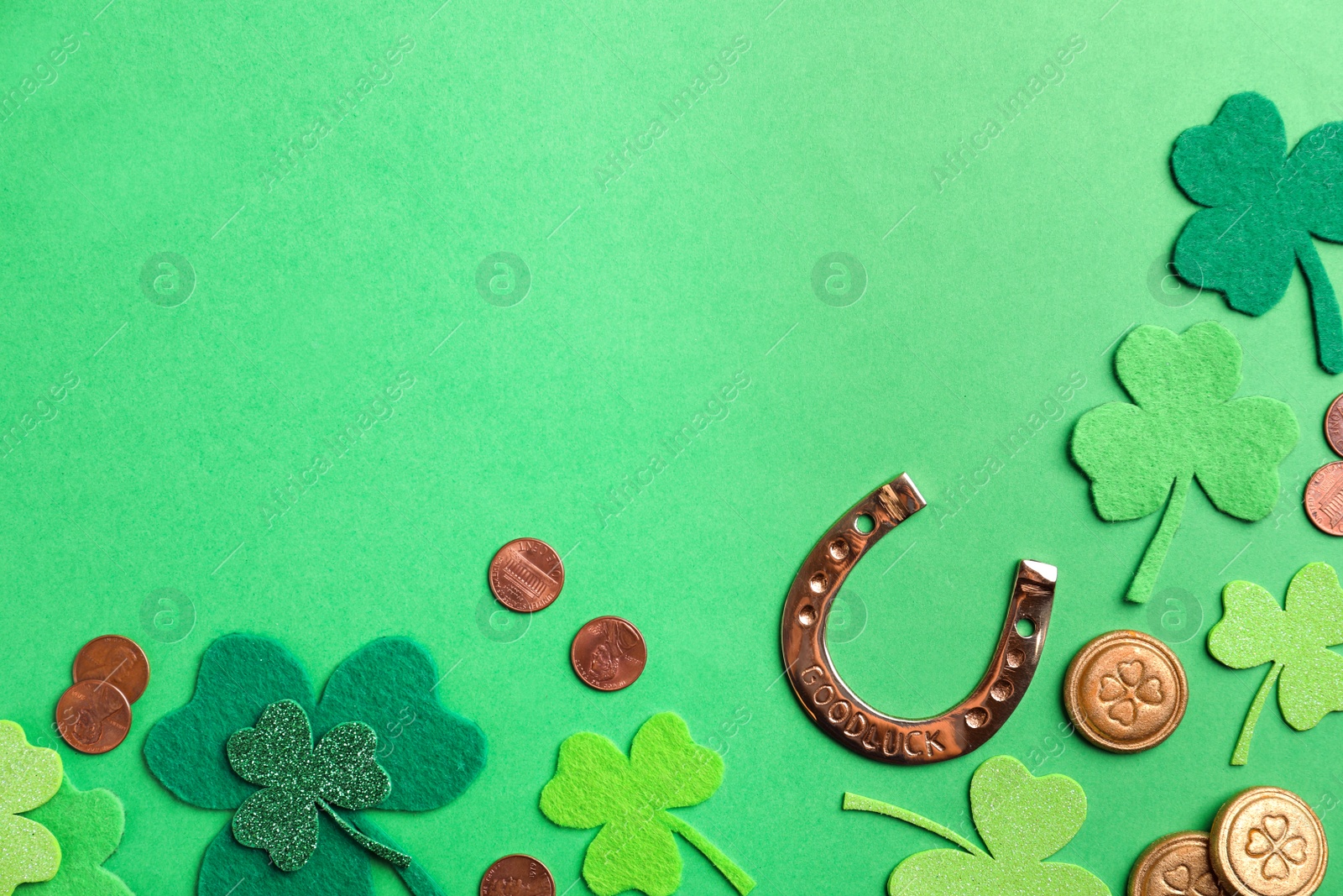 Photo of Flat lay composition with horseshoe on green background, space for text. St. Patrick's Day celebration