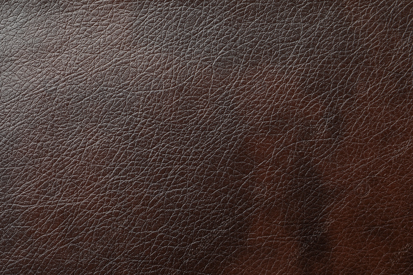 Photo of Texture of dark brown leather as background, closeup