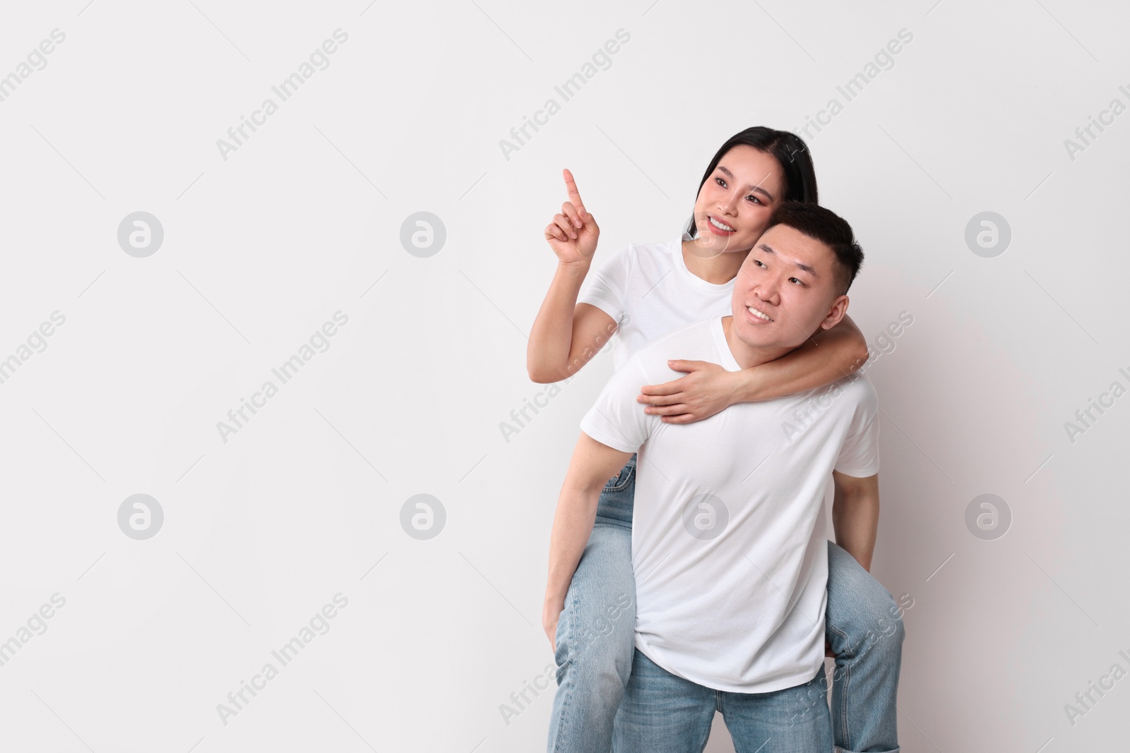 Photo of Portrait of happy couple on white background, space for text