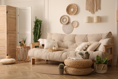 Photo of Stylish living room interior with comfortable wooden sofa and beautiful houseplants