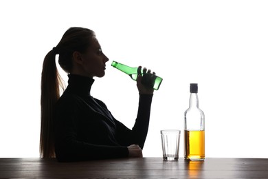 Photo of Alcohol addiction. Woman drinking beer on white background