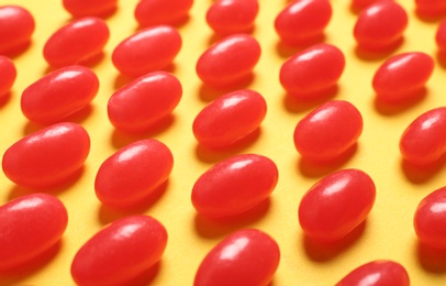 Photo of Delicious jelly beans on color background, closeup