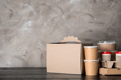 Photo of Various takeout containers on table, space for text. Food delivery service