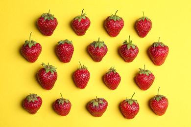 Tasty ripe strawberries on yellow background, flat lay