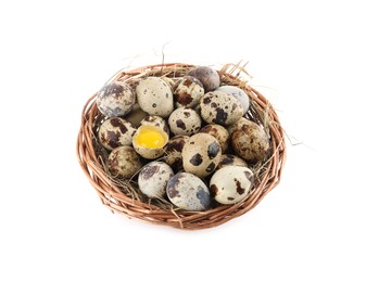 Photo of Wicker bowl with whole, cracked quail eggs and straw isolated on white