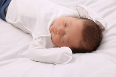 Photo of Cute newborn baby sleeping on white blanket