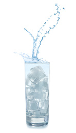 Water splashing out of glass with ice cubes on white background. Refreshing drink