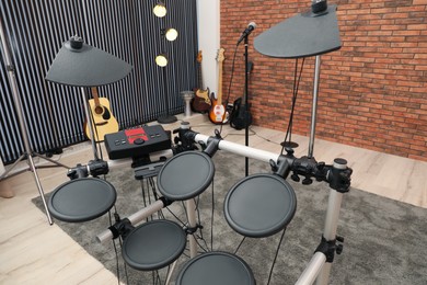 Modern music studio with microphone and different electronic instruments