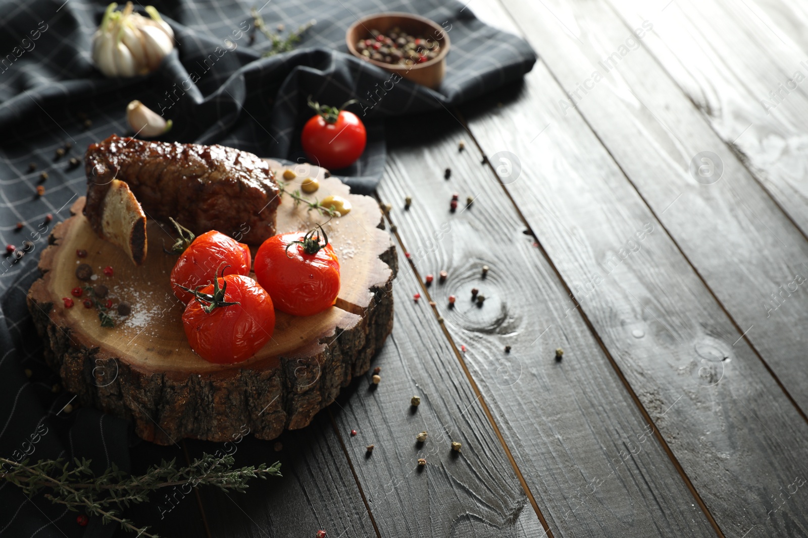 Photo of Delicious roasted rib served on wooden table. Space for text