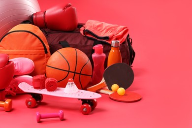 Photo of Many different sports equipment on red background, space for text