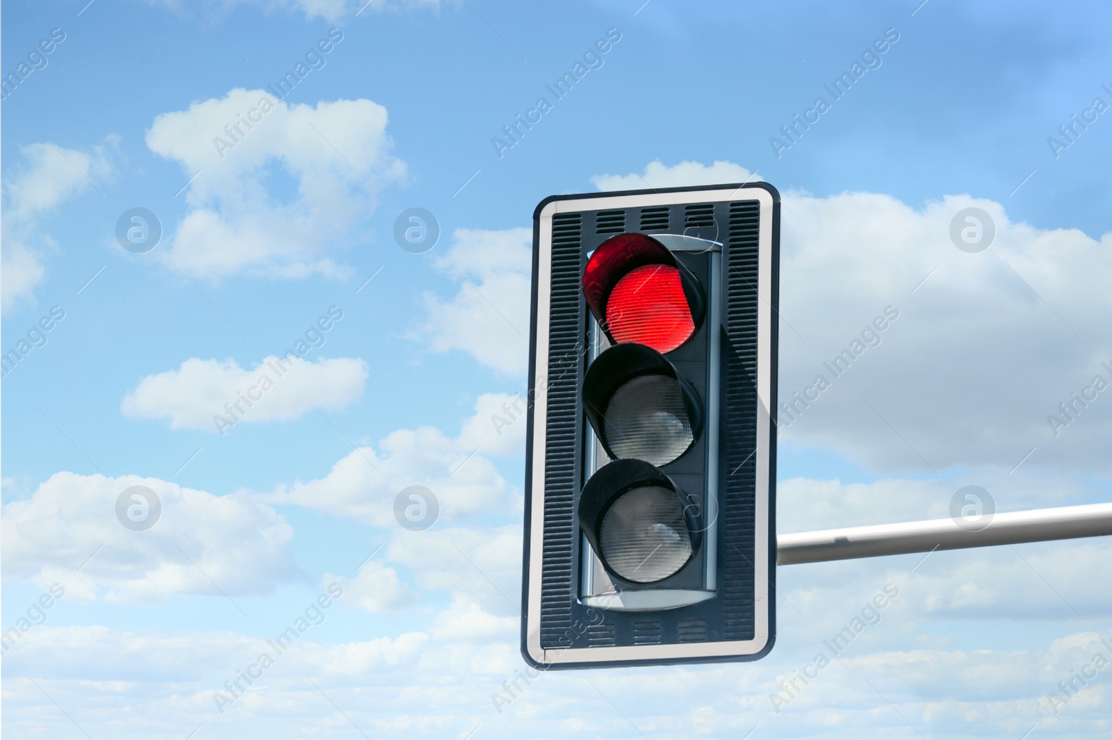 Photo of Traffic light against blue sky, space for text