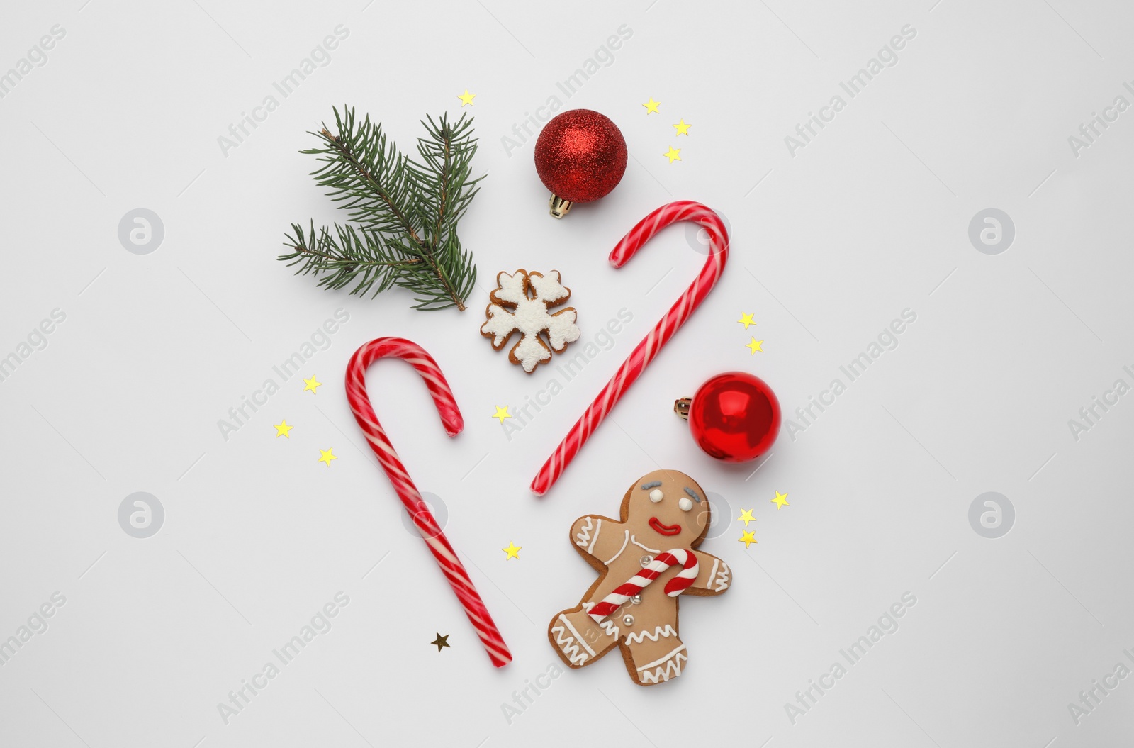 Photo of Flat lay composition with sweet candy canes and Christmas decor on white background