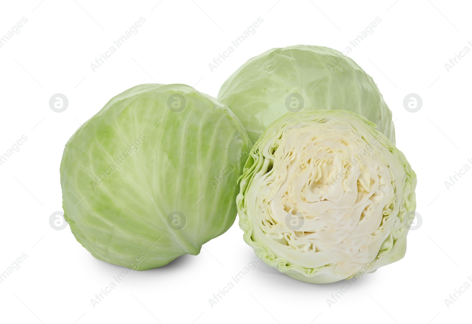 Photo of Whole and cut fresh ripe cabbages on white background