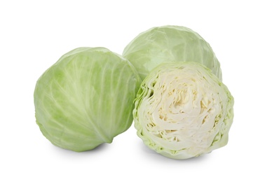 Whole and cut fresh ripe cabbages on white background