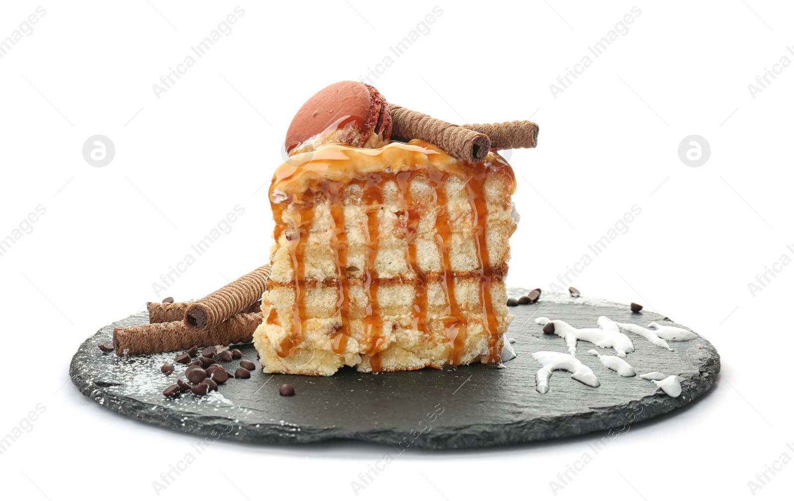 Photo of Piece of delicious homemade cake with caramel sauce white background