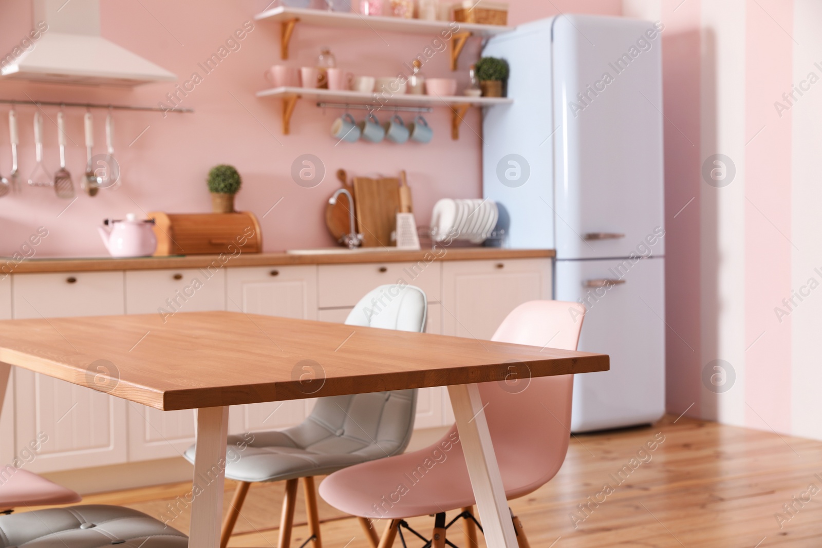 Photo of Stylish kitchen interior with dining table and chairs