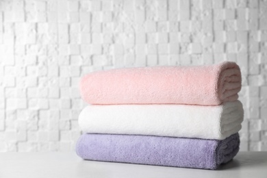 Stack of soft bath towels on table