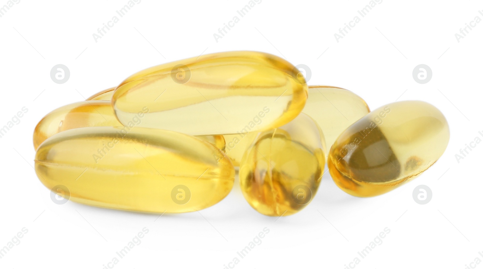 Photo of Many yellow vitamin capsules isolated on white