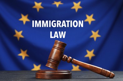 Image of Immigration law. Judge's gavel on black table against flag of European Union