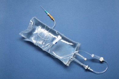 IV infusion set on blue background, top view
