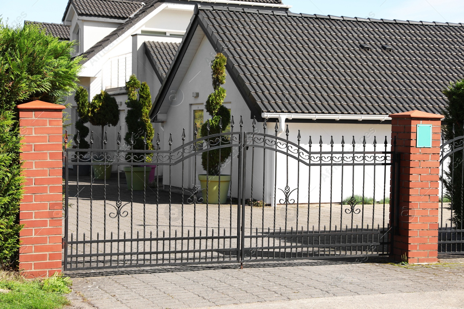Photo of Metal gates near beautiful houses on sunny day