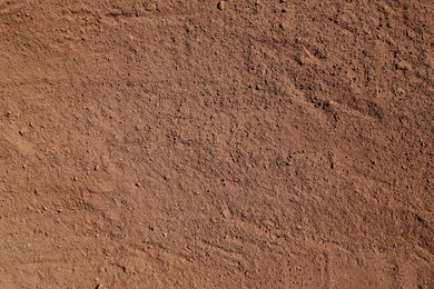 Photo of Textured ground surface as background, top view