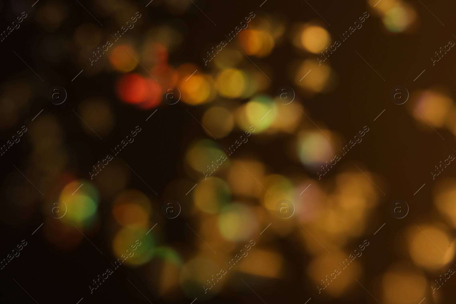 Photo of Blurred view of shiny glitter on black background. Bokeh effect