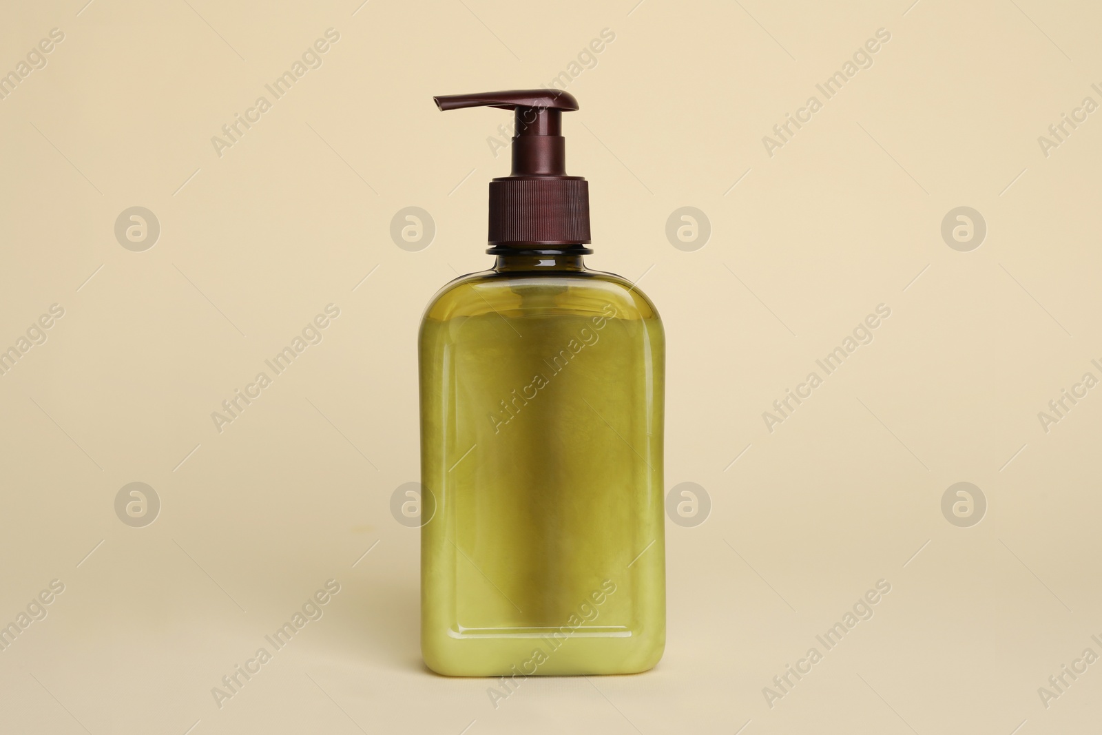 Photo of Bottle of face cleansing product on beige background. Space for text