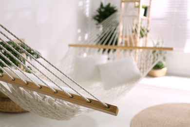 Comfortable net hammock in stylish room, closeup