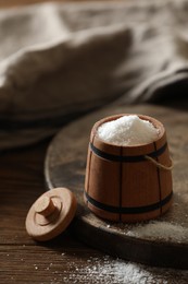 Photo of Organic salt in bowl on wooden table